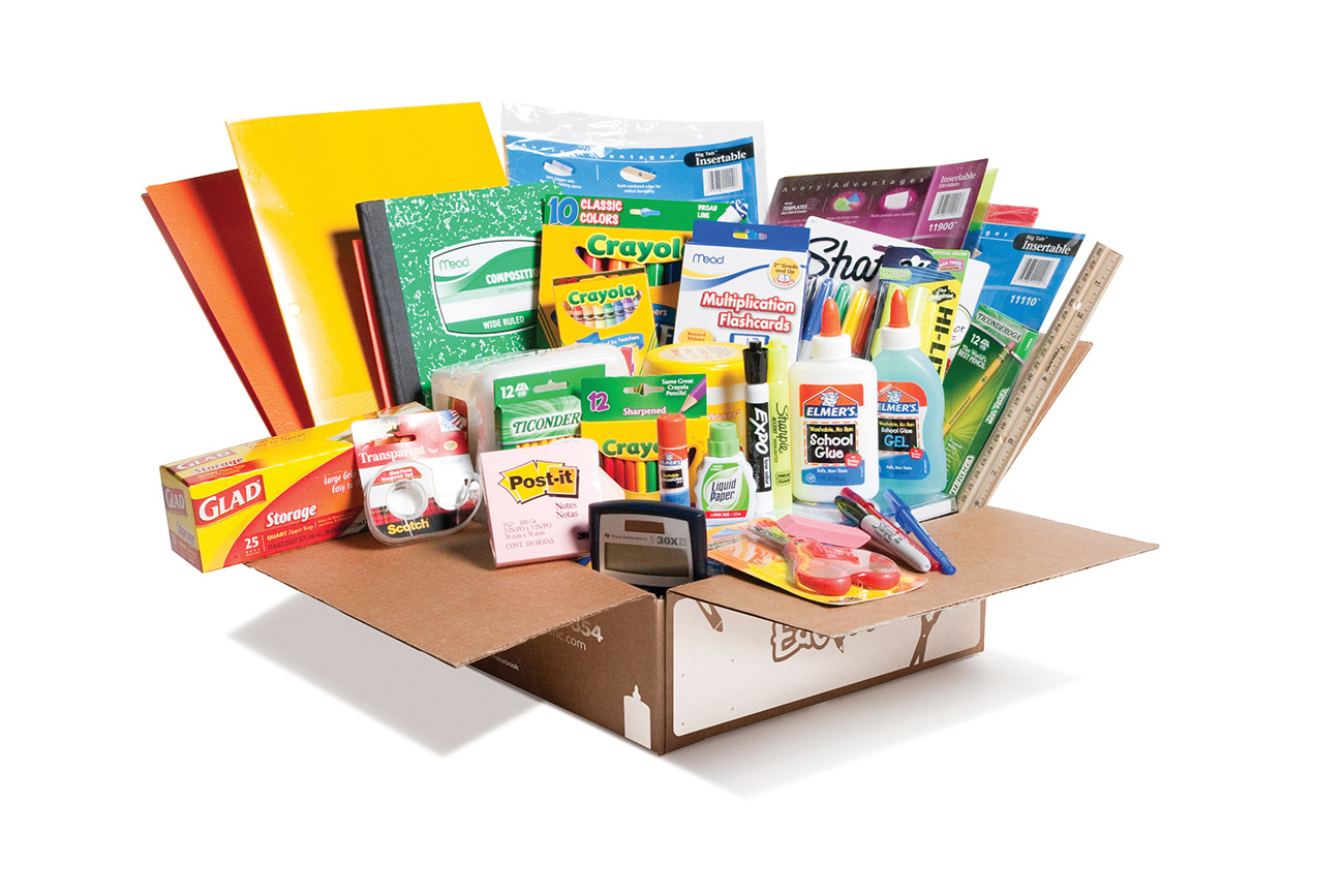 An EduKit box opened with brand-name school supplies neatly tucked inside and standing up in the box