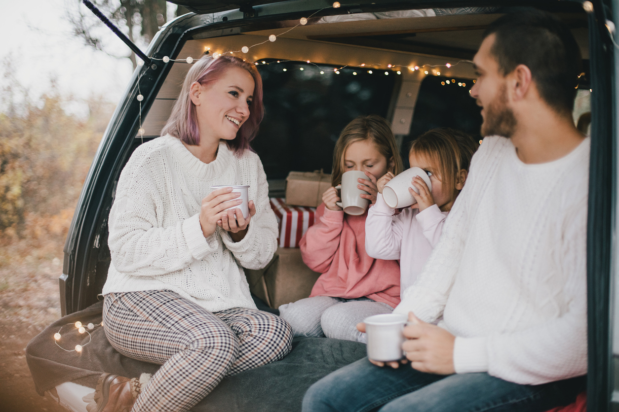 Family of Four Drinking a Hot Chocolate Recipe for Kids in the Back of Their Car