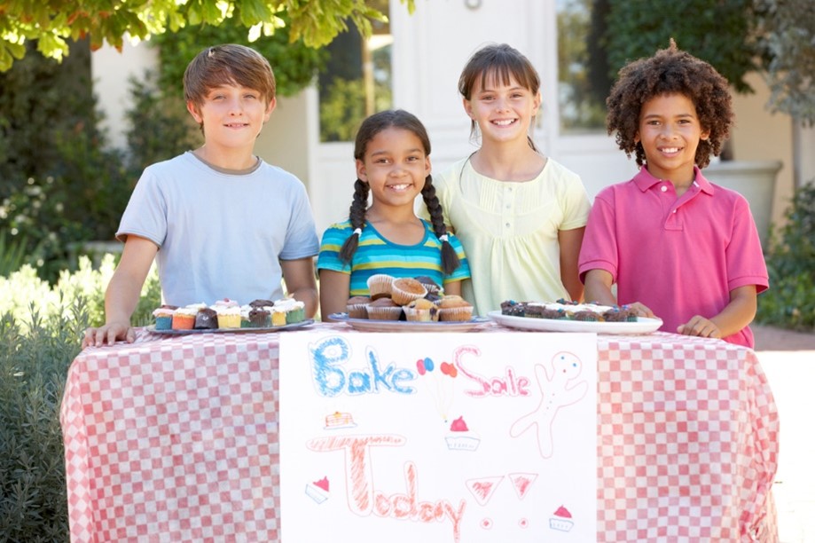 Kids setting up a bake sale for a school fundraising event